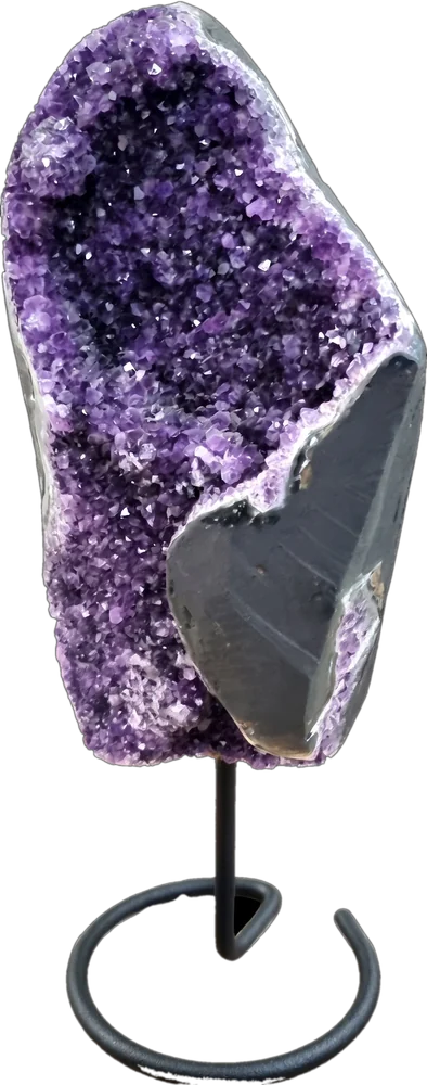 A hand-picked amethyst geode on a display stand from Saluxe